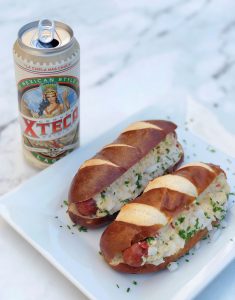 Hot Dog with Pre-Sliced Long Wheat Roll Bun Xteca Beer Can Next to it