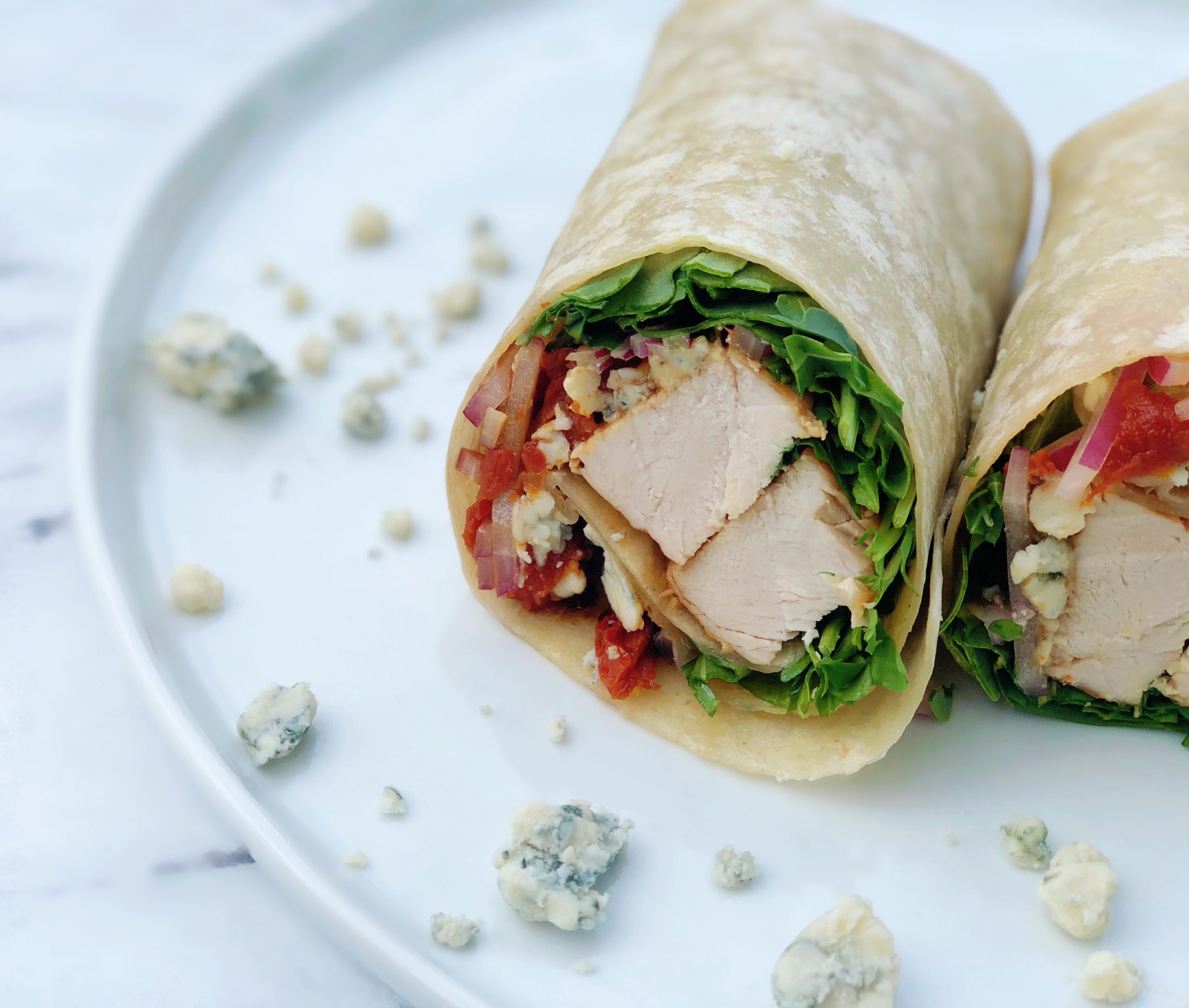 Dish of Balsamic Chicken Wrap with Arugula and Blue Cheese