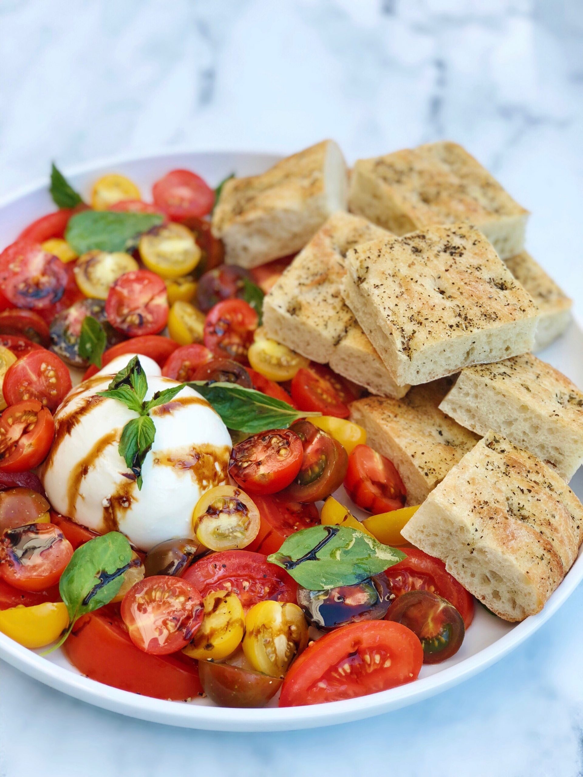 Dish of Burrata and Tomato Salad with Herbed Focaccia