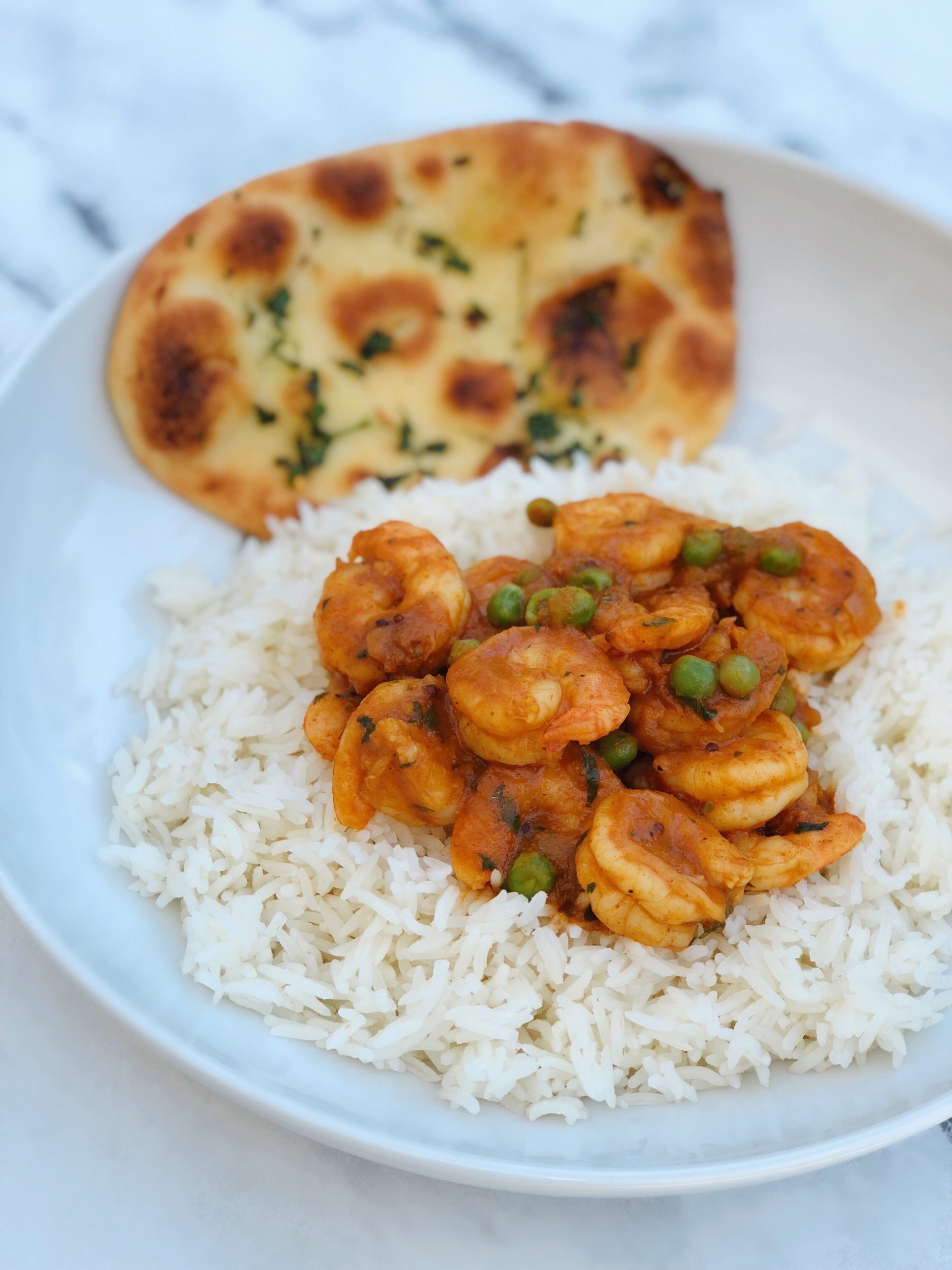 Dish of Shrimp Curry with Garlic Naan