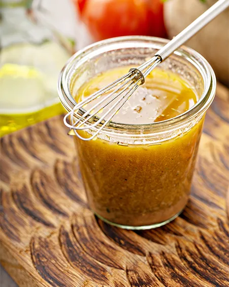 Homemade greek salad dressing or marinade in a glass jar